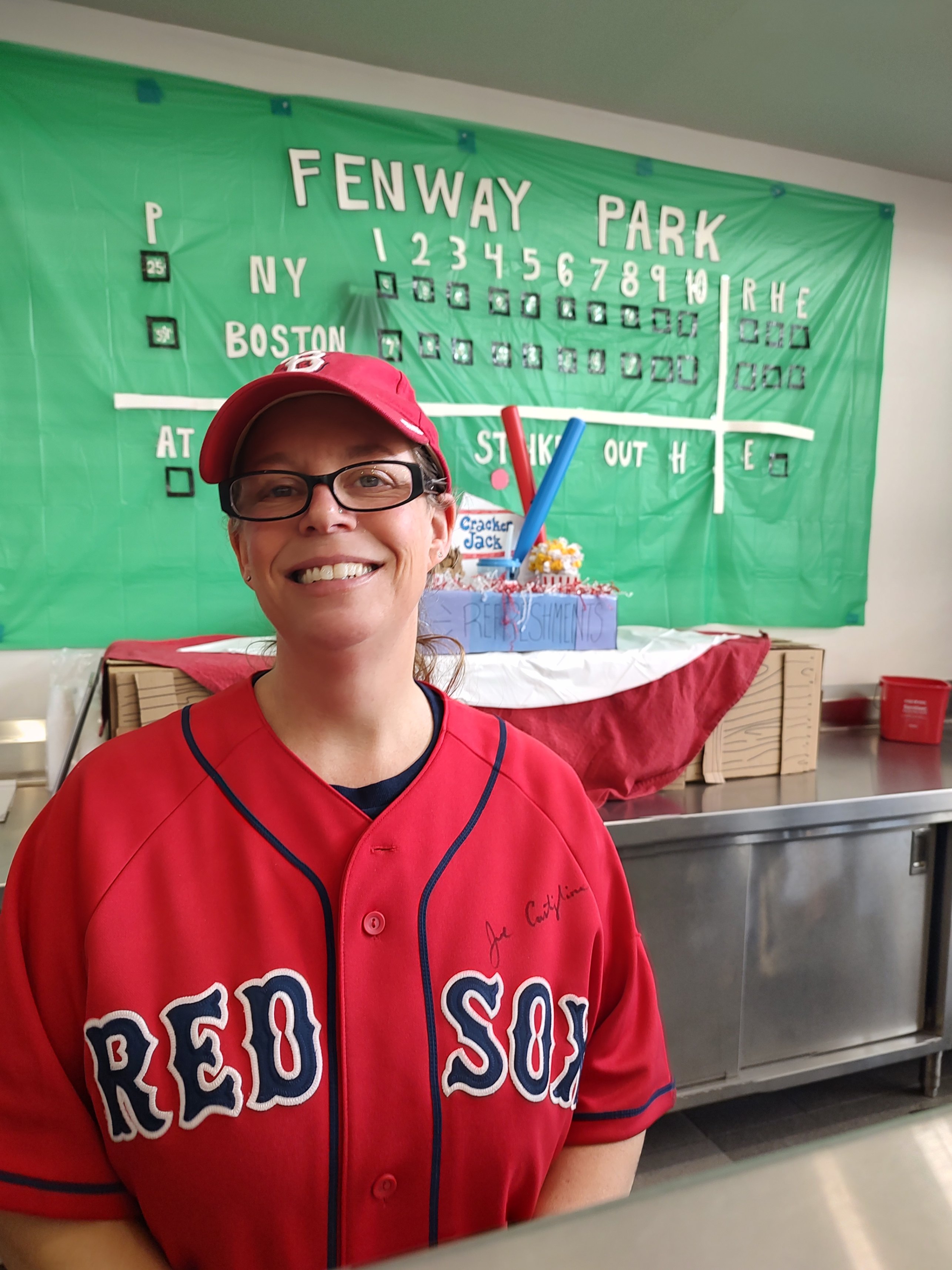 Jen works the snack line at RMS in front of the Green Monster.